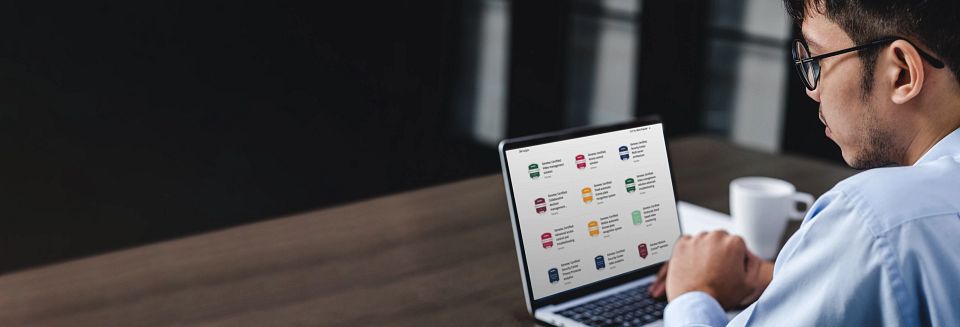Man working on computer looking at digital badges