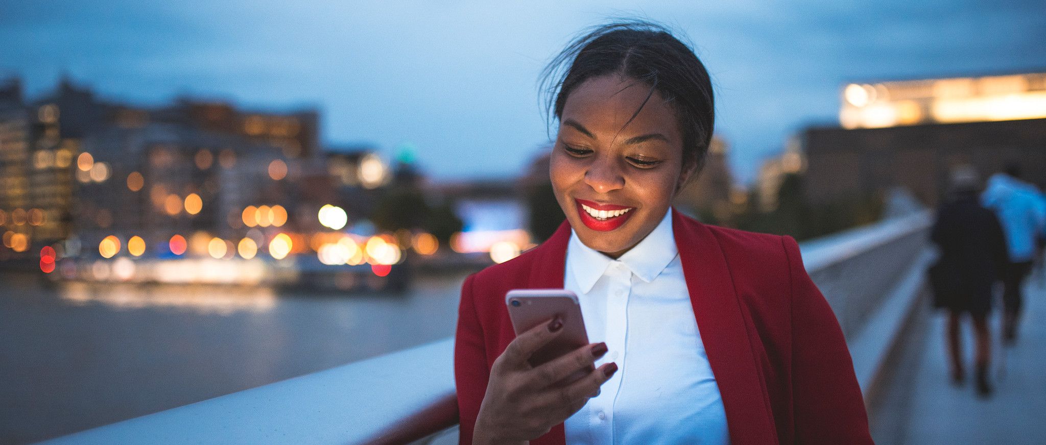 Person looking at cell phone at dusk
