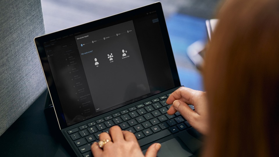 Persoon die toegangsvereisten invoert op laptop met Genetec ClearID-software