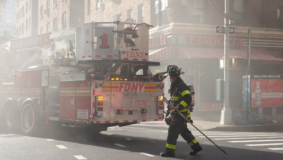 Firefighter and truck in urban environment