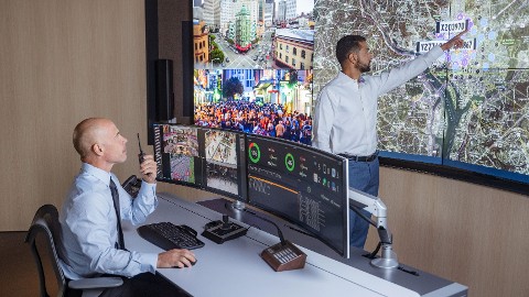 Security operators looking at video surveillance wall