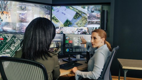 Two people are discussing industrial IoT data on security solutions for retail.