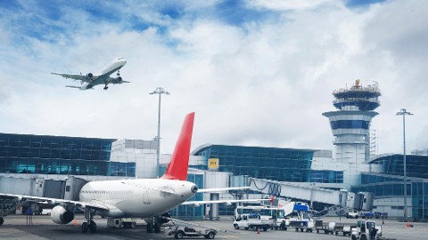 Airport equipped with security solutions by Genetec featuring multiple airplanes at the airport terminal.